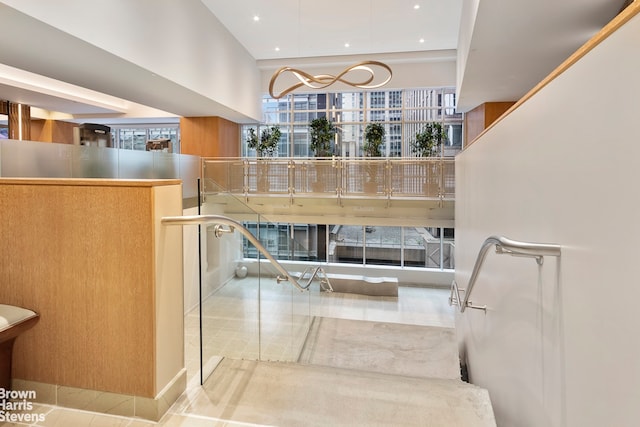 15 W 53rd St Unit 27E, New York City, NY 10019 - stairs with recessed lighting and a towering ceiling