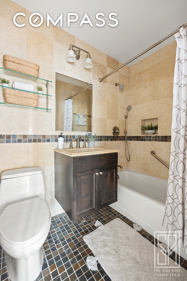 full bath with tile walls, shower / tub combo with curtain, vanity, and toilet