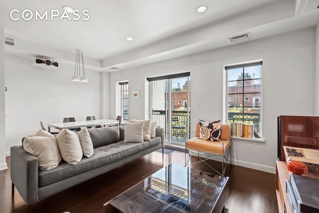 living area featuring baseboards, wood finished floors, and recessed lighting