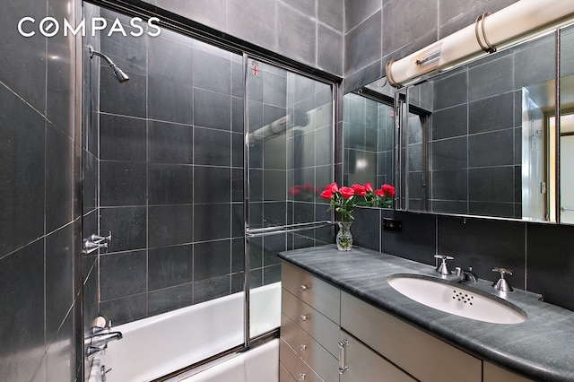 126 W 78th St, New York City, NY 10024 - full bathroom featuring bath / shower combo with glass door, vanity, and decorative backsplash
