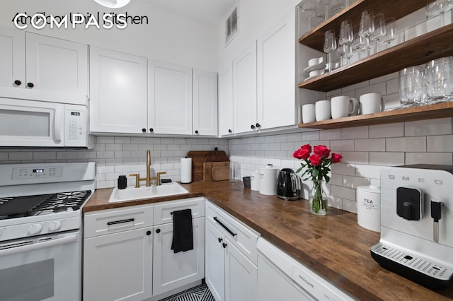 126 W 78th St, New York City, NY 10024 - kitchen with white appliances, a sink, wood counters, and white cabinets