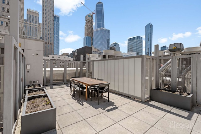view of patio featuring outdoor dining space and a city view
