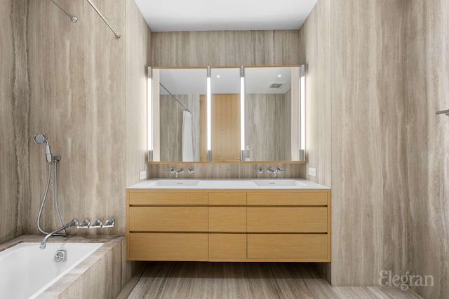 bathroom with double vanity and a sink