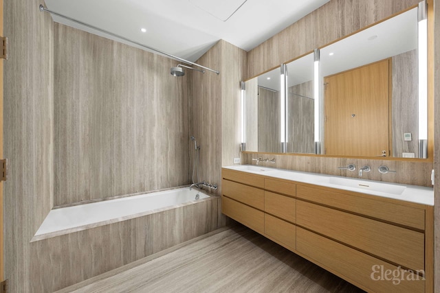 full bathroom with shower / tub combination, a sink, and double vanity