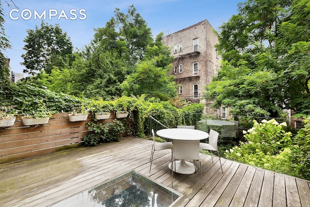 wooden deck with fence and outdoor dining area
