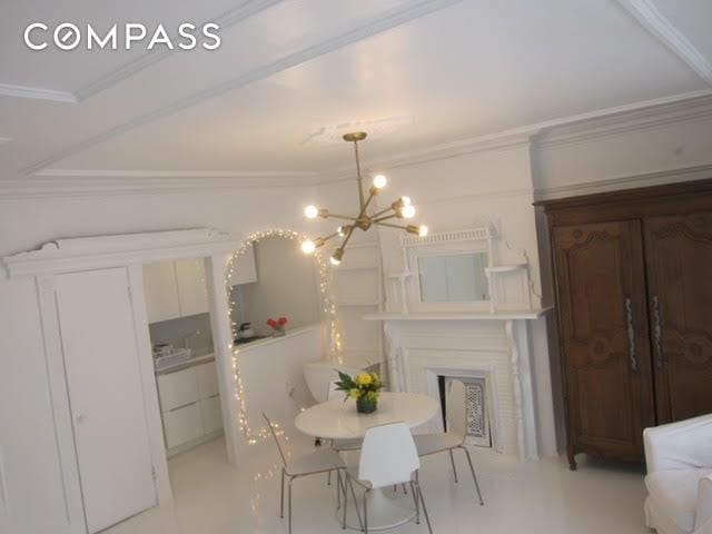 dining space with a notable chandelier and ornamental molding