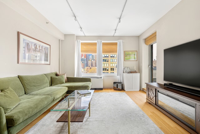 303 E 33rd St Unit 7C, New York City, NY 10016 - living room with rail lighting, plenty of natural light, and light wood finished floors