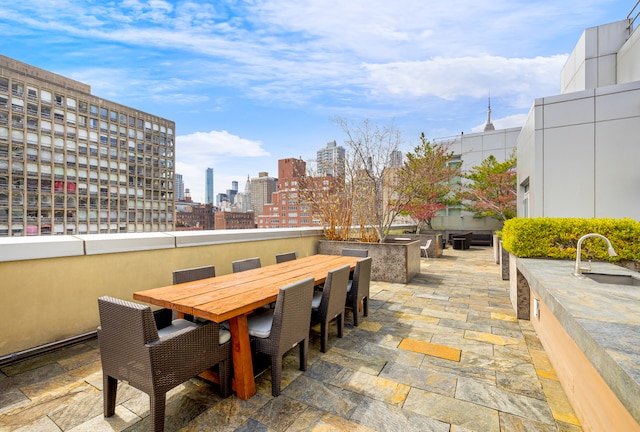 303 E 33rd St Unit 7C, New York City, NY 10016 - view of patio with a sink, a view of skyline, and outdoor dining space
