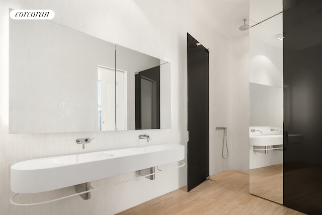 56 Leonard St Unit 44Be, New York City, NY 10013 - full bathroom featuring wood finished floors, a walk in shower, and a sink