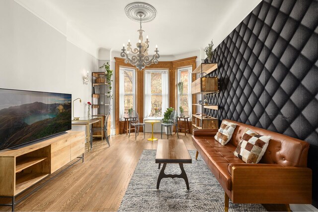 living area featuring a chandelier and wood finished floors