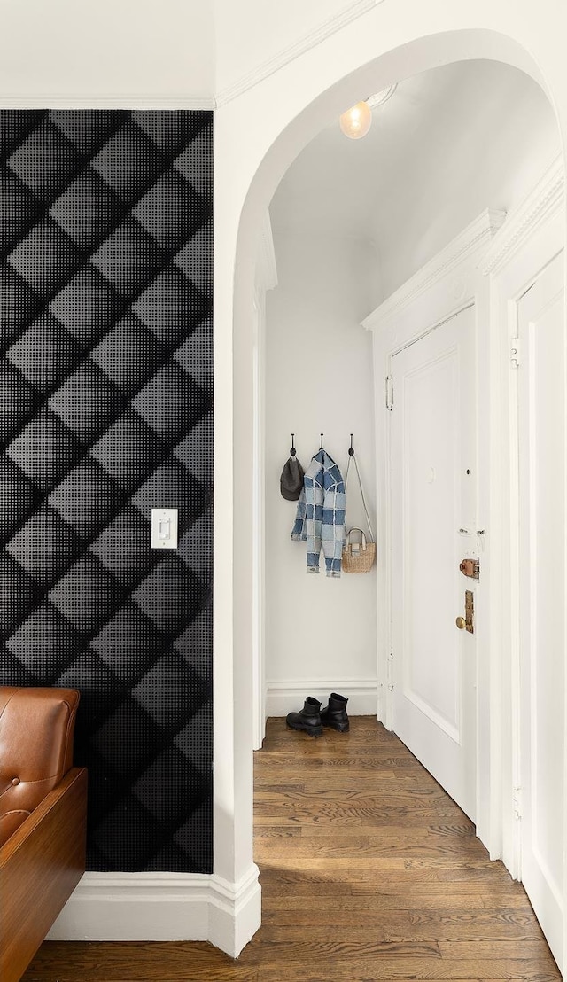 mudroom with arched walkways and wood finished floors