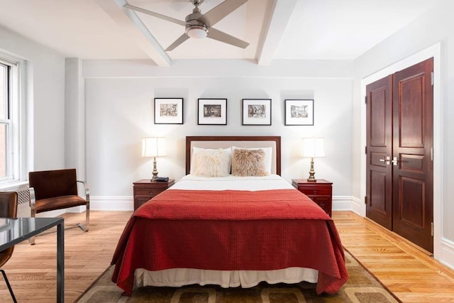 433 W 34th St Unit 5L, New York City, NY 10001 - bedroom with beam ceiling, light wood-style floors, baseboards, and ceiling fan