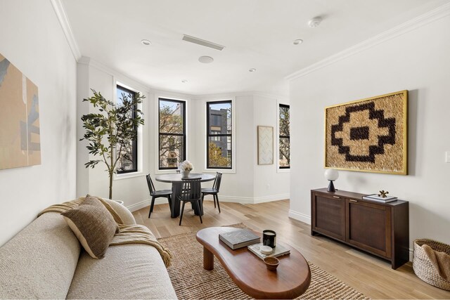 80 Cornelia St Unit 2, New York City, NY 11221 - living room with crown molding, light wood-style flooring, baseboards, and recessed lighting