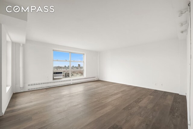 501 W 123rd St Unit 21D, New York City, NY 10027 - unfurnished room featuring wood finished floors and a baseboard radiator