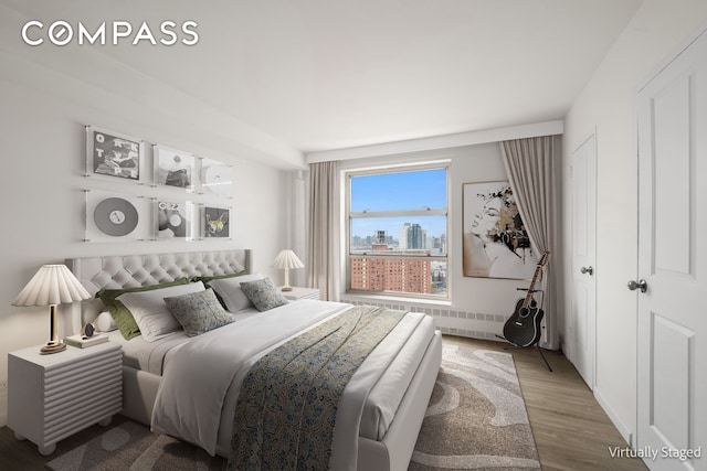 501 W 123rd St Unit 21D, New York City, NY 10027 - bedroom featuring wood finished floors and radiator