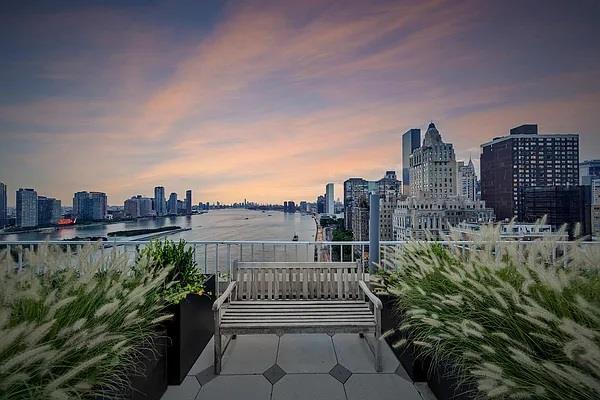 balcony with a view of city and a water view