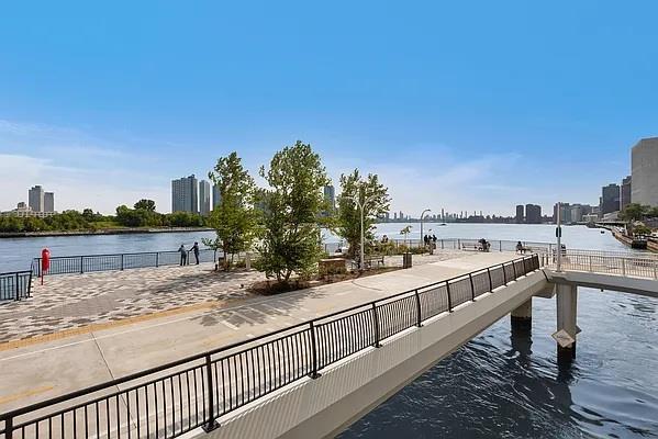 dock area featuring a water view and a view of city