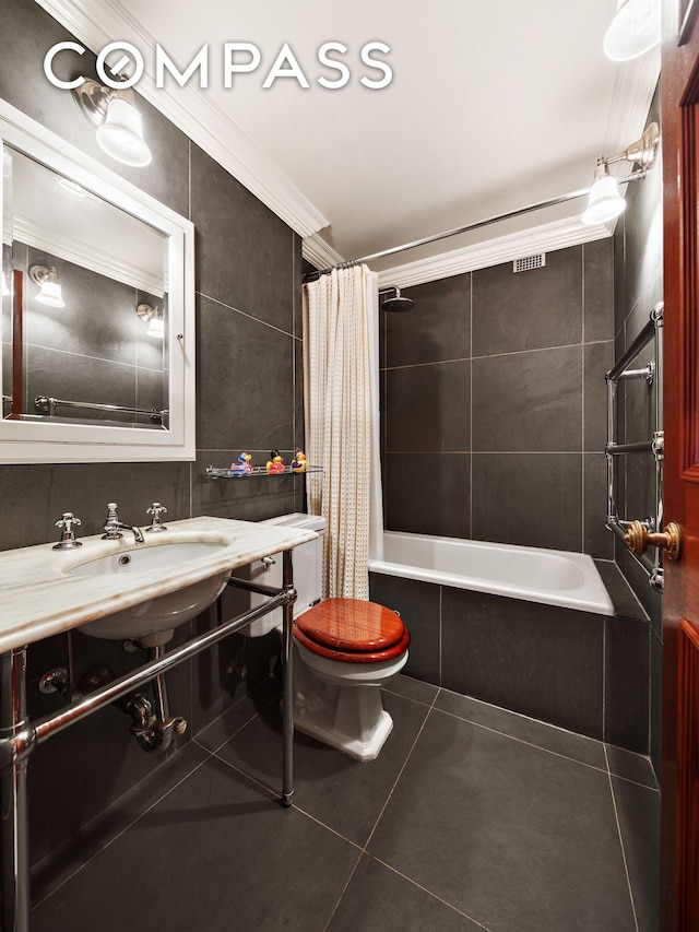 45 E End Ave Unit 10F, New York City, NY 10028 - full bath with tile patterned floors, toilet, tile walls, shower / bath combo with shower curtain, and crown molding