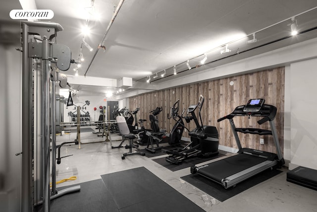 gym with wood walls and rail lighting