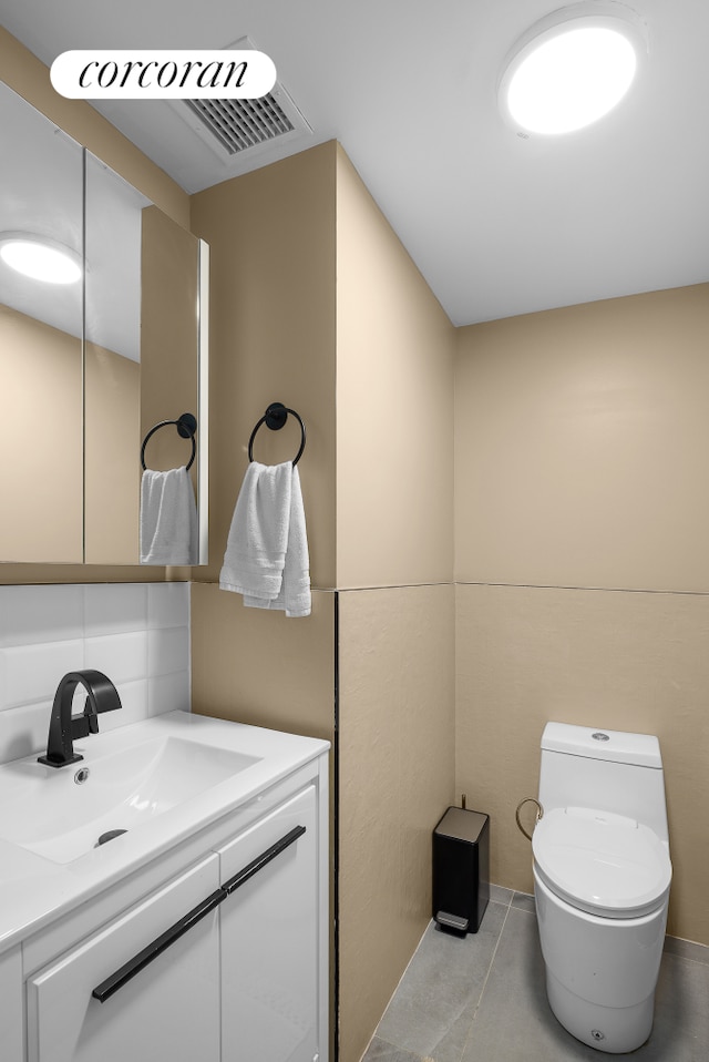bathroom with toilet and vanity