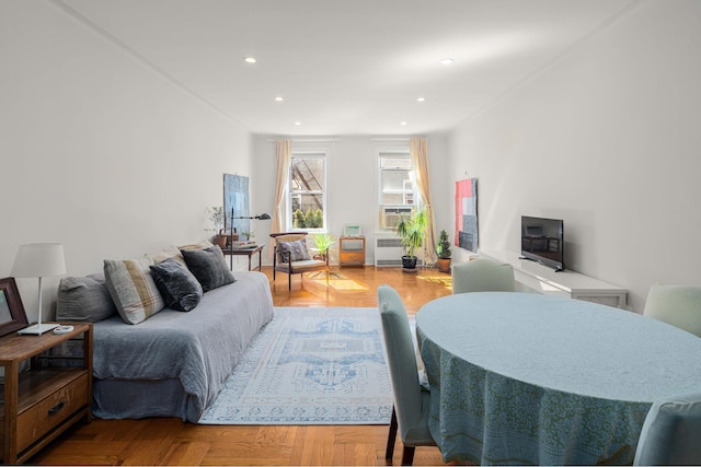 living area featuring radiator, recessed lighting, and cooling unit