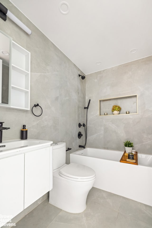 1020 Hancock St Unit 1A, New York City, NY 11221 - bathroom featuring tile walls, vanity, washtub / shower combination, and tile patterned flooring
