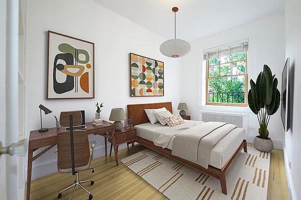 bedroom featuring radiator and wood finished floors