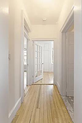 hallway with baseboards and wood finished floors