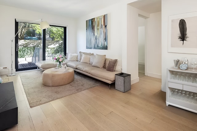 living area with hardwood / wood-style floors and baseboards