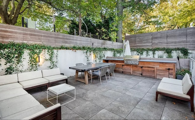 view of patio with a grill, area for grilling, outdoor lounge area, outdoor dining area, and a fenced backyard