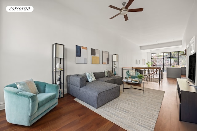 living room with visible vents, wood finished floors, and ceiling fan