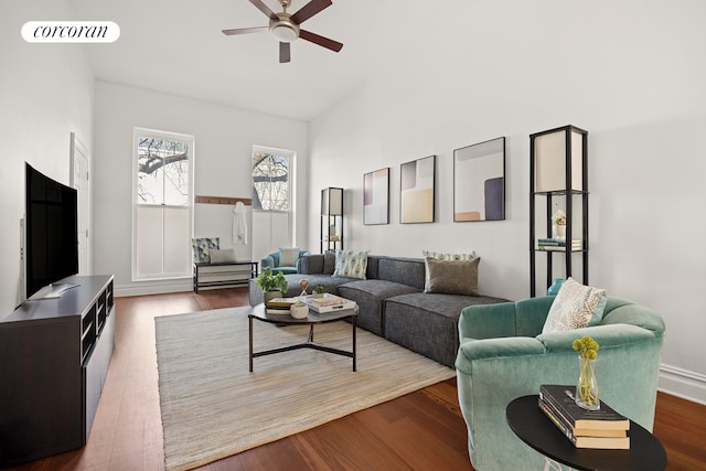living area featuring dark wood finished floors, visible vents, a ceiling fan, and high vaulted ceiling