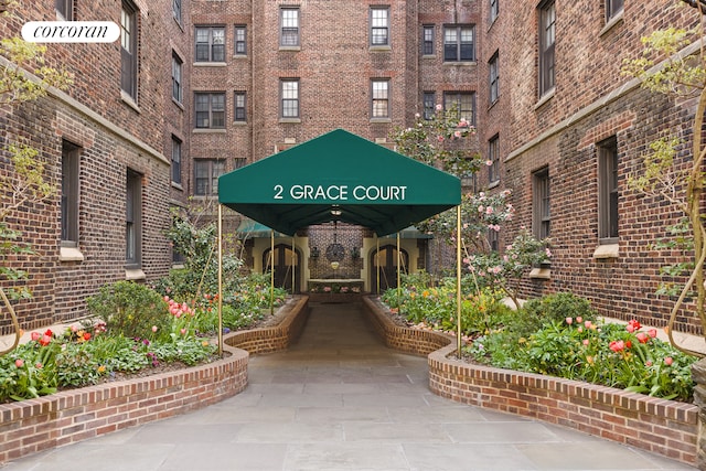 view of exterior entry featuring brick siding