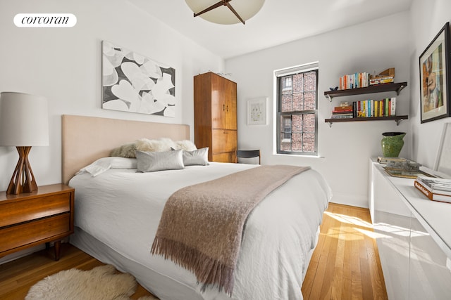 bedroom featuring baseboards and wood finished floors