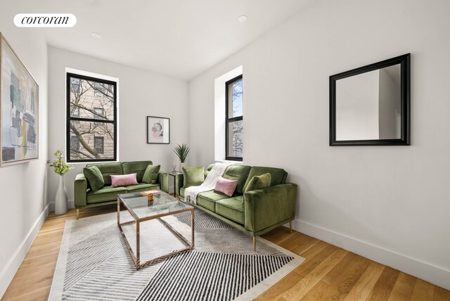 1474 Bushwick Ave Unit 2R, New York City, NY 11207 - living room featuring baseboards and light wood-style floors