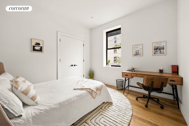 1474 Bushwick Ave Unit 2R, New York City, NY 11207 - bedroom with light wood-style flooring, baseboards, and an office area