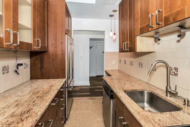 67-25 Clyde St Unit 1G, New York City, NY 11375 - kitchen with pendant lighting, glass insert cabinets, tasteful backsplash, a sink, and appliances with stainless steel finishes
