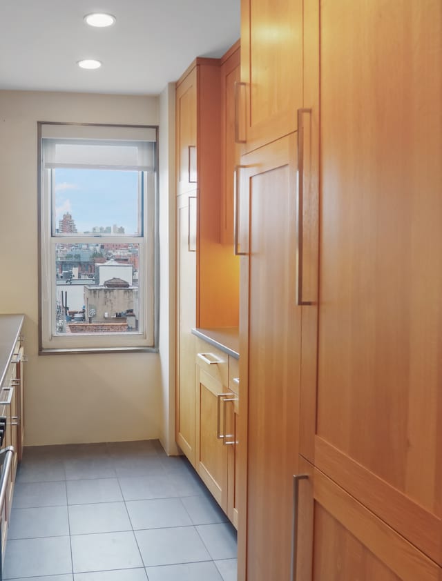 kitchen featuring light tile patterned floors, recessed lighting, baseboards, and light countertops