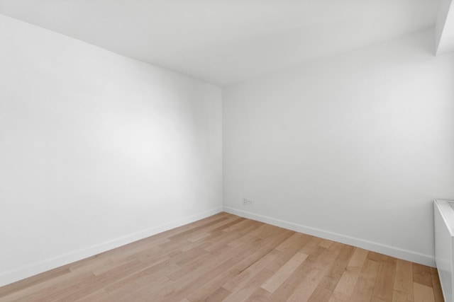 empty room featuring light wood-style flooring and baseboards
