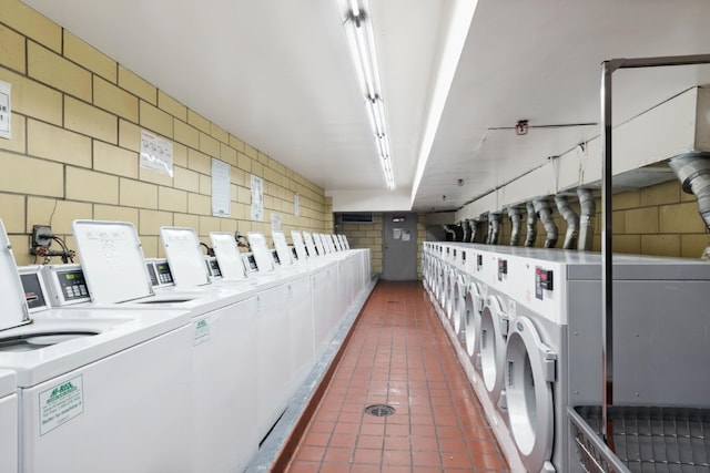 345 E 80th St Unit 18A, New York City, NY 10075 - community laundry with washing machine and dryer and tile patterned flooring