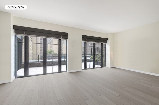 959 1st Ave Unit 6G, New York City, NY 10022 - empty room with baseboards and wood finished floors