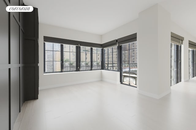 959 1st Ave Unit 6G, New York City, NY 10022 - unfurnished room featuring wood finished floors and baseboards