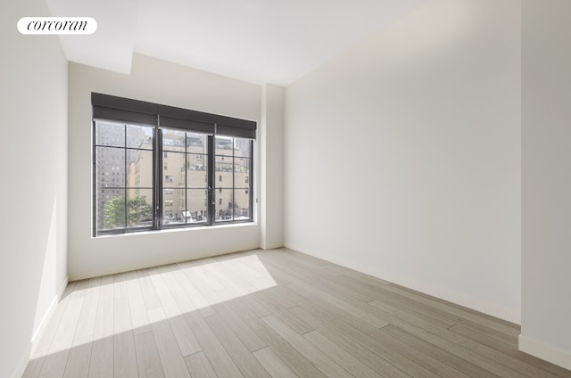 959 1st Ave Unit 6G, New York City, NY 10022 - spare room with wood finished floors and baseboards