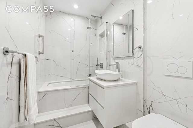 bathroom with tile walls, vanity, toilet, and a combined bath / shower with marble appearance