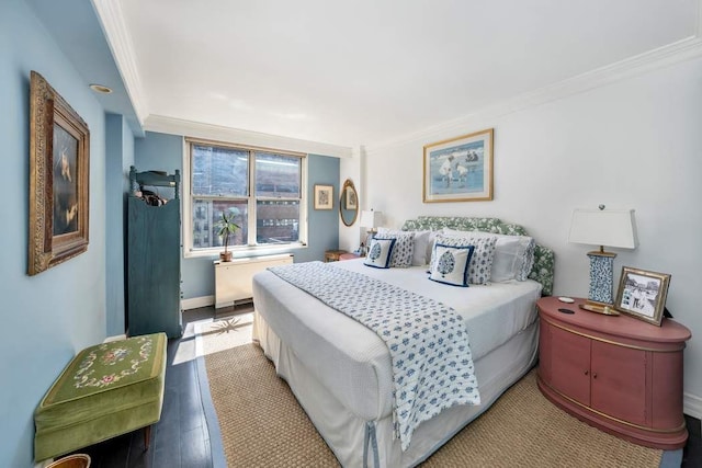 207 E 74th St Unit 7F, New York City, NY 10021 - bedroom featuring crown molding, radiator heating unit, wood finished floors, and baseboards
