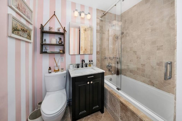 207 E 74th St Unit 7F, New York City, NY 10021 - bathroom featuring wallpapered walls, tiled shower / bath combo, toilet, and vanity