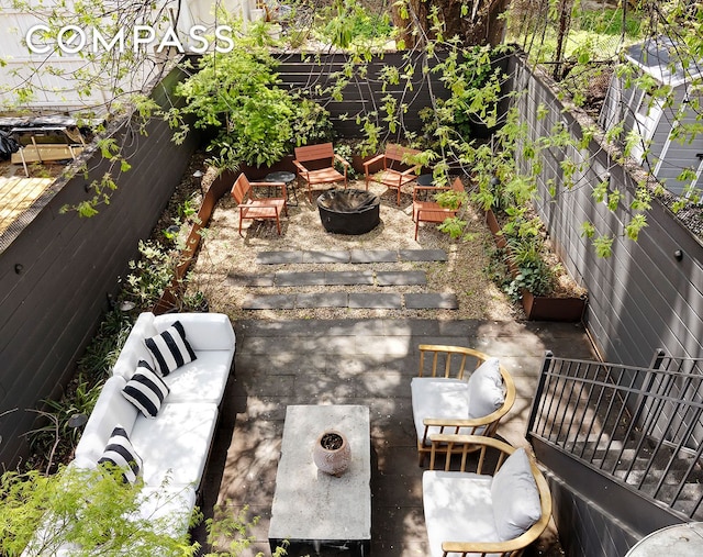 view of patio with fence and an outdoor fire pit