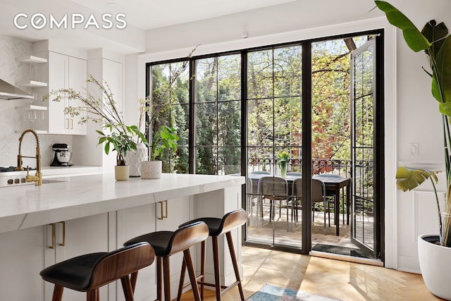 doorway to outside with a sink and a wealth of natural light