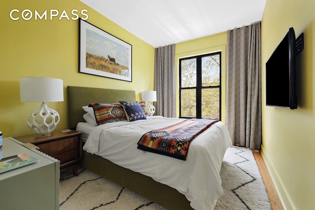 bedroom with baseboards and carpet flooring