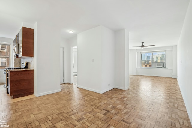 575 Grand St Unit E1806, New York City, NY 10002 - unfurnished living room with ceiling fan, baseboards, and cooling unit